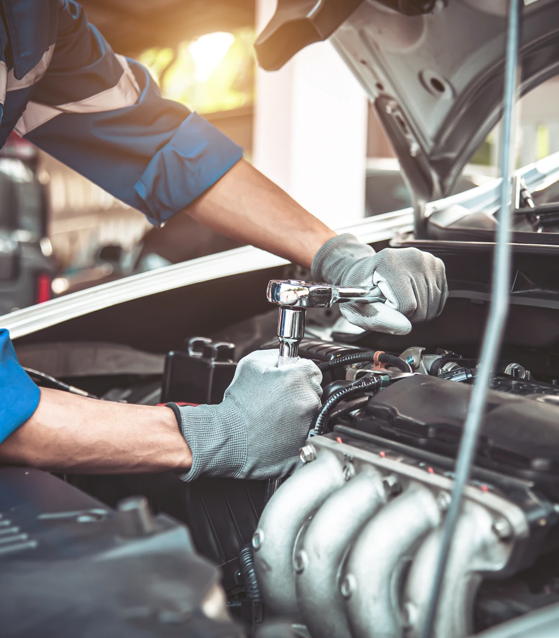Mechanic working on car engine