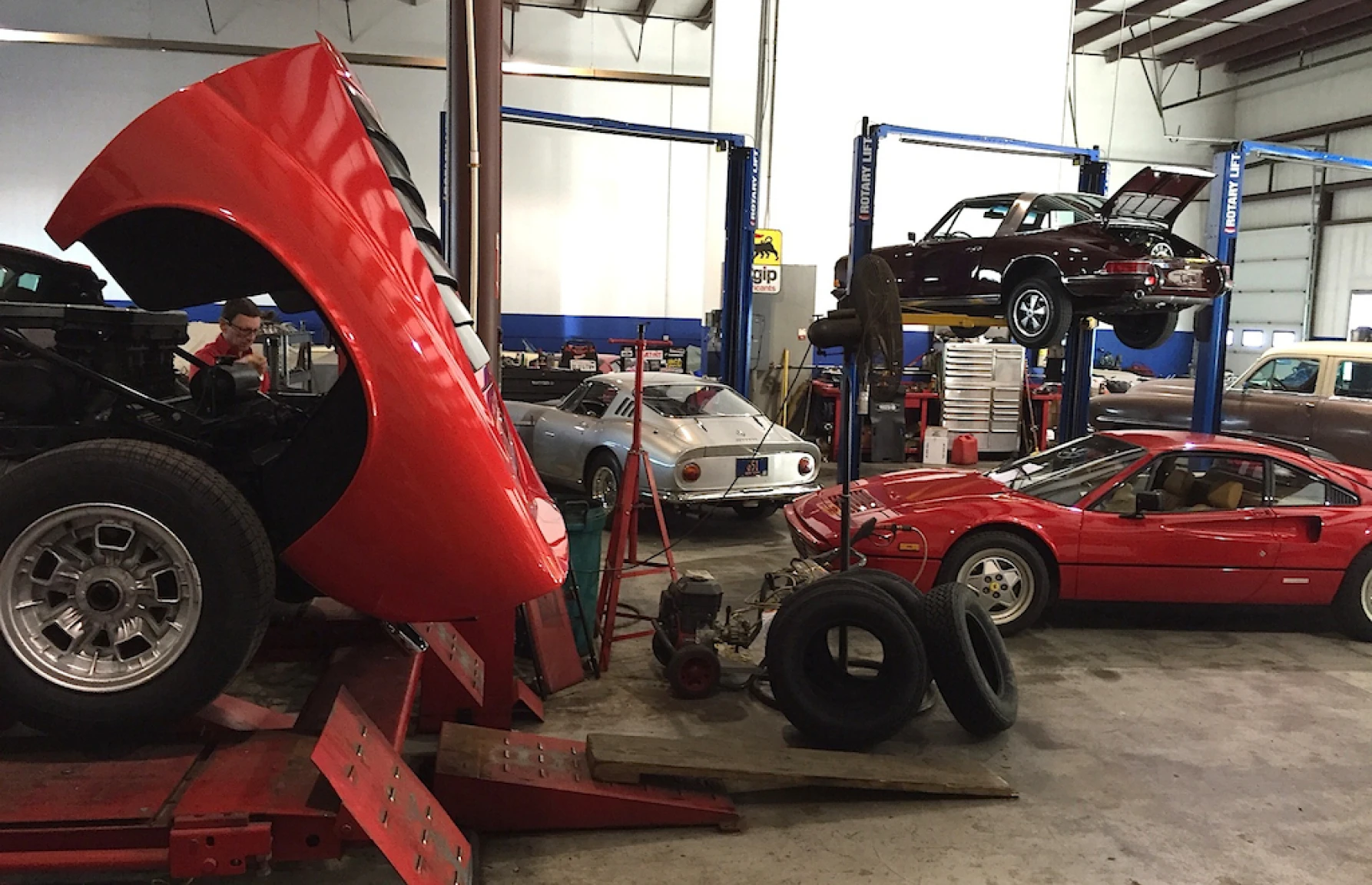 Vintage cars on lifts in garage